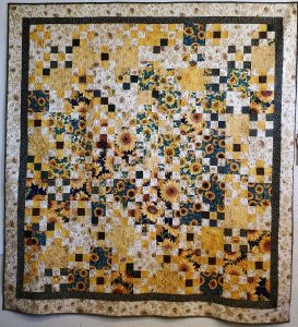 handmade quilt with many squares containing sunflowers